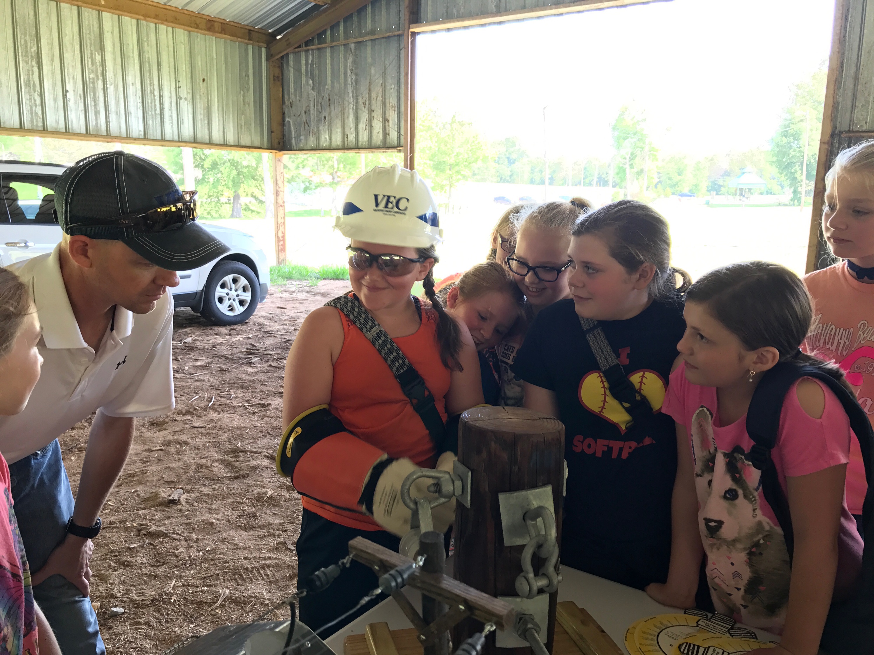 Safety Superintendent Ty Ratcliff teaches middle school students some of the safety difficulties linemen face.